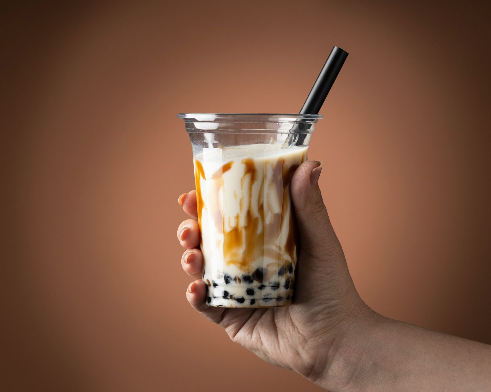 Bubble tea served over ice with a wide straw